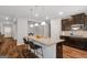 Stylish kitchen featuring a granite island with seating, stainless appliances, and modern pendant lighting at 1243 Polk Xing, Mcdonough, GA 30252