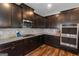 Beautiful kitchen showcasing stainless steel appliances, stylish countertops, dark cabinets, and modern design at 1243 Polk Xing, Mcdonough, GA 30252