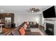 Cozy living room with fireplace, large sectional sofa, modern ceiling fan, next to kitchen at 1243 Polk Xing, Mcdonough, GA 30252