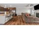 Inviting living space with a fireplace, a ceiling fan, and hardwood floors, viewed from the kitchen at 1243 Polk Xing, Mcdonough, GA 30252