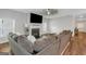 Bright living room with a fireplace, large windows, and comfortable seating on a large couch at 1243 Polk Xing, Mcdonough, GA 30252