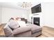 Cozy living room features a fireplace, large sectional sofa, and plenty of natural light at 1243 Polk Xing, Mcdonough, GA 30252