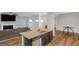Living space with a kitchen island, fireplace, and an abundance of natural light from the large windows at 1243 Polk Xing, Mcdonough, GA 30252