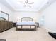 Spacious primary bedroom featuring tray ceilings, a ceiling fan, and neutral carpeting at 1243 Polk Xing, Mcdonough, GA 30252