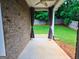 A backyard patio with concrete flooring, brick walls, and green grass at 1243 Polk Xing, Mcdonough, GA 30252