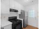 Well-lit kitchen with white cabinets, black appliances, and access to the outdoors at 150 Glynn Addy Dr, Stockbridge, GA 30281