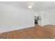 Open-concept space with hardwood floors, white walls, and a view into the kitchen area at 150 Glynn Addy Dr, Stockbridge, GA 30281
