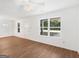 Inviting living area with hardwood floors, white walls, and windows offering outdoor views at 150 Glynn Addy Dr, Stockbridge, GA 30281