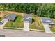 A sunny day highlights the front of the home, set amid green lawns, adjacent to neighboring houses and lush trees at 340 Indian Lake Trl, Villa Rica, GA 30180