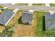 An aerial view shows this home's roof, backyard with seating area, and adjacent lawns with surrounding homes at 340 Indian Lake Trl, Villa Rica, GA 30180