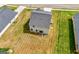 An aerial view showcases the home's backyard with a small seating area, roof, and surrounding green lawn at 340 Indian Lake Trl, Villa Rica, GA 30180