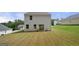 Expansive backyard with lush green grass and a patio seating area at 340 Indian Lake Trl, Villa Rica, GA 30180