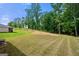 Spacious backyard with lush green grass and mature trees at 340 Indian Lake Trl, Villa Rica, GA 30180