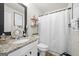 Well-lit bathroom with granite countertop, stylish fixtures, and shower with curtain at 340 Indian Lake Trl, Villa Rica, GA 30180