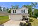Well-maintained home showcasing a clean white facade, dark shutters, and a spacious driveway at 340 Indian Lake Trl, Villa Rica, GA 30180