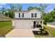 Charming two-story home boasts a white exterior, a well-manicured lawn, and inviting curb appeal at 340 Indian Lake Trl, Villa Rica, GA 30180