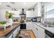 Well-lit kitchen featuring granite countertops, black appliances, and island for food prep and storage at 340 Indian Lake Trl, Villa Rica, GA 30180