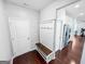 A foyer features an entryway bench and coat rack with white trim and hardwood floors at 5229 Tye, Fairburn, GA 30213