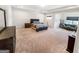 An expansive main bedroom boasts tray ceilings, neutral colors, and a sitting area for relaxation at 5229 Tye, Fairburn, GA 30213