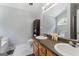 Bright bathroom with dual sink vanity, a large mirror, and natural light at 5832 Whitney Way, Rex, GA 30273