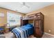Cozy bedroom with a lofted bed, desk area, and a bright window for natural light at 5832 Whitney Way, Rex, GA 30273