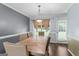 Elegant dining room with a spacious wooden table and stylish chairs, perfect for Gathering gatherings at 5832 Whitney Way, Rex, GA 30273