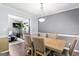 Well-lit dining area showcasing a wooden table and comfortable seating adjacent to the living room at 5832 Whitney Way, Rex, GA 30273