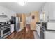 Functional kitchen with stainless steel appliances, white cabinets, and ample counter space for cooking at 5832 Whitney Way, Rex, GA 30273
