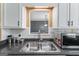 Stainless steel kitchen sink with updated faucet and view into another room at 5832 Whitney Way, Rex, GA 30273