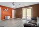 Living room with ample space, ceiling fan, and convenient backyard access through double doors at 5832 Whitney Way, Rex, GA 30273