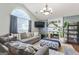 Cozy living room with a fireplace, large windows, and stylish decor providing a relaxing ambiance at 5832 Whitney Way, Rex, GA 30273