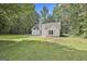 Wide shot of the backyard showing the house, shed, patio and lush green grass at 288 Winthrop Dr, Sharpsburg, GA 30277