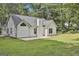 Back of house featuring a concrete patio, large yard, and classic white siding at 288 Winthrop Dr, Sharpsburg, GA 30277