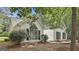 Charming single-Gathering home boasts a striking arched window and black shutters, nestled amongst mature trees at 288 Winthrop Dr, Sharpsburg, GA 30277
