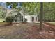 Charming single-Gathering home boasts a striking arched window and black shutters, nestled amongst mature trees at 288 Winthrop Dr, Sharpsburg, GA 30277