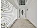 Home features a covered front porch and detailed oval glass front door, situated along the home's vinyl siding at 288 Winthrop Dr, Sharpsburg, GA 30277