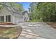 Attached two-car garage featuring a wide driveway, situated on a landscaped lot with a partial fence at 288 Winthrop Dr, Sharpsburg, GA 30277