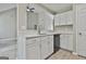 Kitchen with gray walls, wood-look floors, white cabinets, and stainless steel dishwasher at 288 Winthrop Dr, Sharpsburg, GA 30277