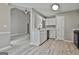 Kitchen features gray walls, wood-look floors, white cabinets and an open floorplan at 288 Winthrop Dr, Sharpsburg, GA 30277