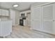 Kitchen with new appliances, gray walls, wood-look floors, and white cabinetry at 288 Winthrop Dr, Sharpsburg, GA 30277