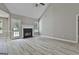 Bright living room with gray walls, wood-look floors, a ceiling fan and a fireplace at 288 Winthrop Dr, Sharpsburg, GA 30277
