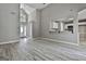 Bright living room with open floorplan, high ceilings, gray walls, and wood-look floors at 288 Winthrop Dr, Sharpsburg, GA 30277