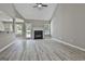 Bright living room with gray walls, wood-look floors, a ceiling fan and a fireplace at 288 Winthrop Dr, Sharpsburg, GA 30277