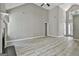 Bright living room features vaulted ceiling, gray walls, wood-look floors, and neutral color scheme at 288 Winthrop Dr, Sharpsburg, GA 30277