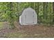 A close-up of the storage shed nestled in the woods, offering extra storage space at 288 Winthrop Dr, Sharpsburg, GA 30277