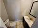 Cozy half-bathroom with a marble vanity and a standard toilet at 3140 Kipling Dr, Powder Springs, GA 30127