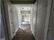 Bright hallway with closet space and modern flooring, connecting various rooms of the home at 3140 Kipling Dr, Powder Springs, GA 30127