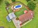 Aerial view of a home with a large yard, pool, detached garage, and outbuildings at 552 New Hope Rd, Mcdonough, GA 30252