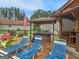 Backyard with lounge chairs, spa, outdoor kitchen, pool house and mature trees at 552 New Hope Rd, Mcdonough, GA 30252