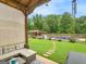 Backyard with pool, pool house, seating area, lush lawn, and mature trees at 552 New Hope Rd, Mcdonough, GA 30252